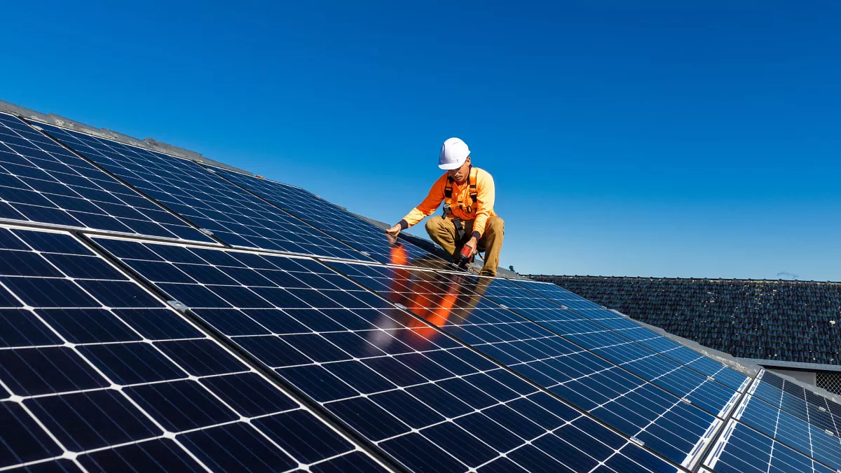 A worker installing a solar panel