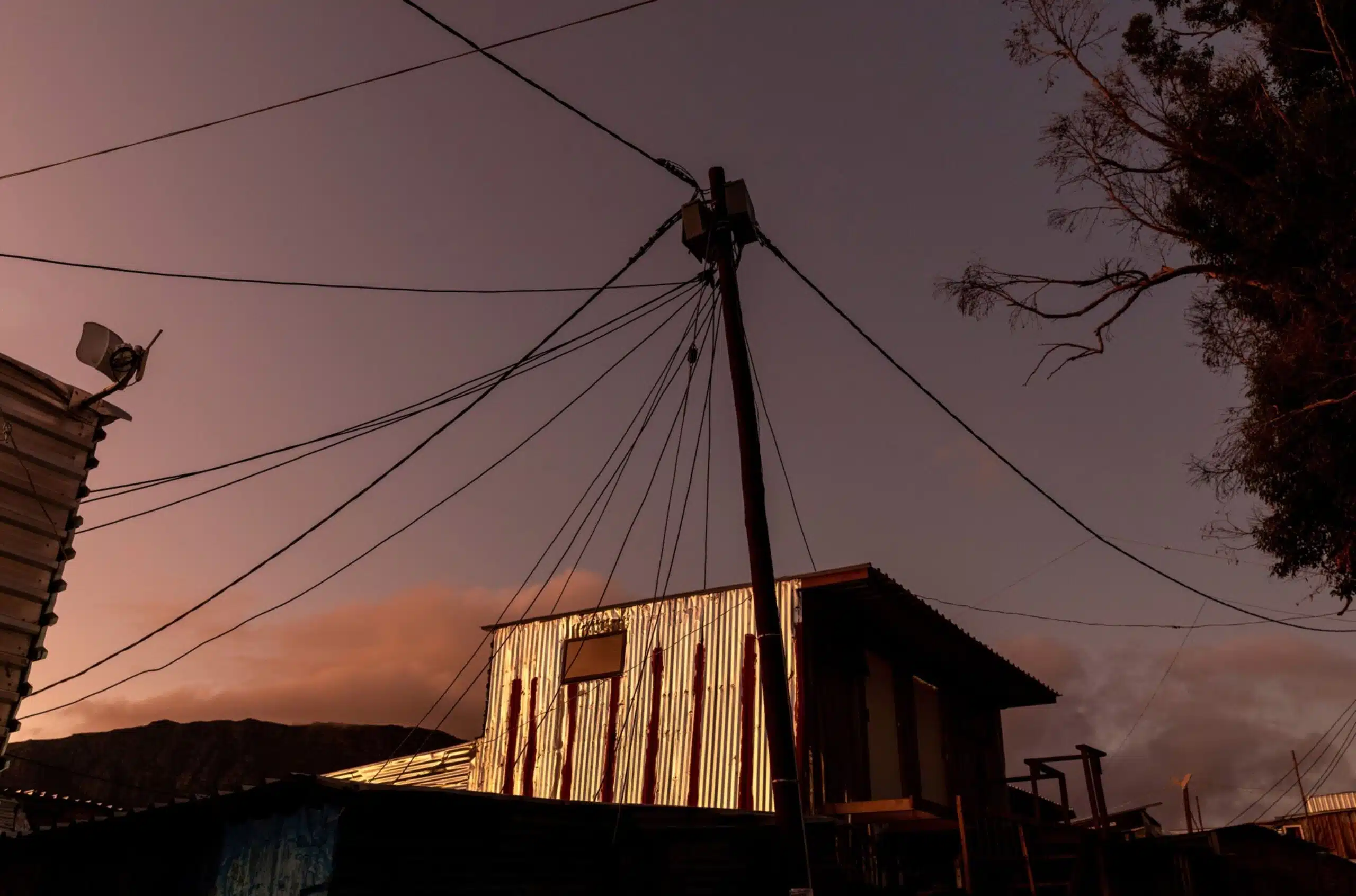 Electricity power line towering over a rural community in Africa