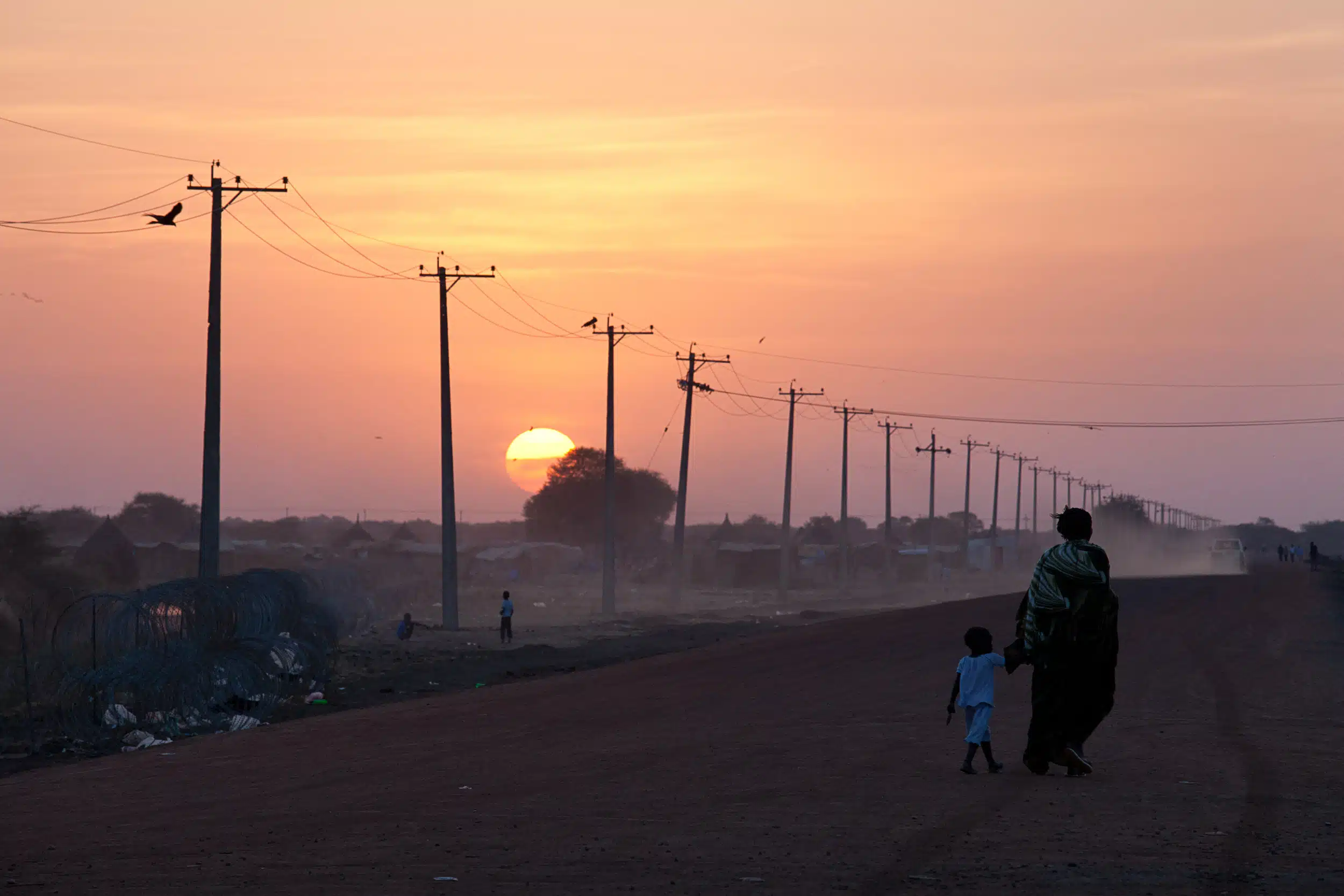 Electricity transmission line across a road in Africa